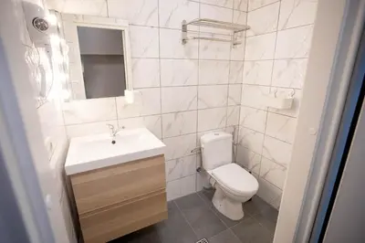 a white bathroom with a sink and a toilet at Hostel K3a in Vilnius