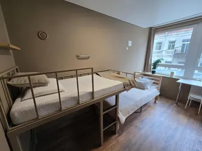 a bedroom with a bunk bed and a window at Hostel K3a in Vilnius