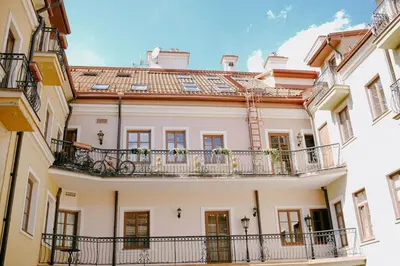 a large white building with balconies and windows at Central apartment in Gaono residence in Vilnius