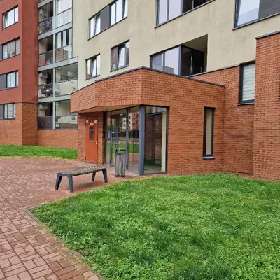 a brick building with a bench in front of it at Vilnius Lazdynėliai in Pakopi