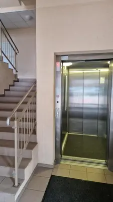 an elevator in a building with a staircase at Vilnius Lazdynėliai in Pakopi