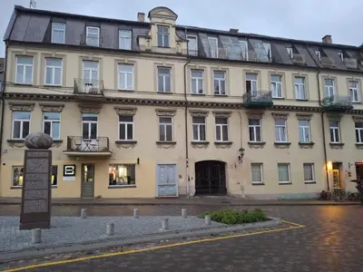 a large building with a sign in front of it at Apartment in Heart of Užupis - perfect location in Vilnius