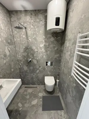 a bathroom with a toilet and a sink and a tub at 5 New Airport Apartment in VNO
