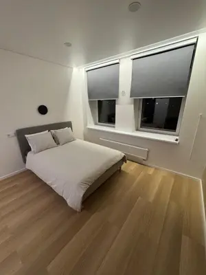 a bedroom with a bed and a large window at 6 New Airport Apartment in VNO
