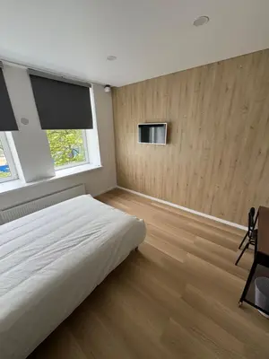 a bedroom with a white bed and a window at 6 New Airport Apartment in VNO