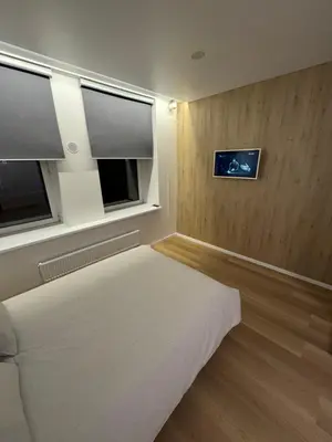 a bedroom with a bed and two windows in it at 6 New Airport Apartment in VNO