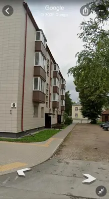 a building with arrows pointing towards a parking lot at Centro apartamentai in Biržai