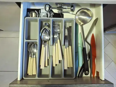 a utensil holder with utensils in a drawer at Cozy Studio in Vilnius Old Town in Vilnius