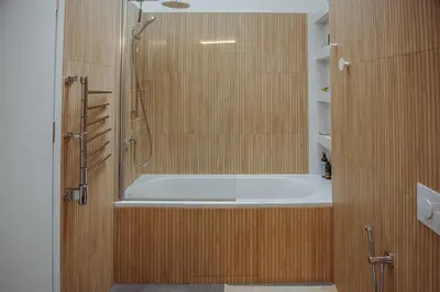 a bathroom with a bath tub and a shower at Oak Zen Home in Birštonas