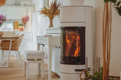 a fireplace in a living room with a stove at Oak Zen Home in Birštonas