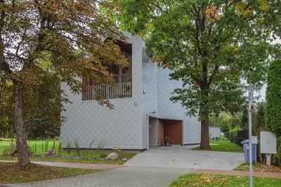 a white building with a window on the side of it at Oak Zen Home in Birštonas