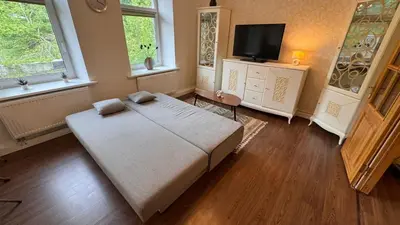 a bedroom with a large bed and a flat screen tv at Cozy stay Vilnius in Vilnius