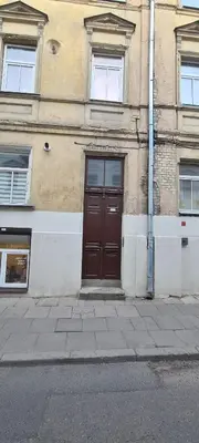 a brown door on the side of a building at Cozy stay Vilnius in Vilnius