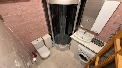 a small bathroom with a toilet and a shower at Cozy stay Vilnius in Vilnius