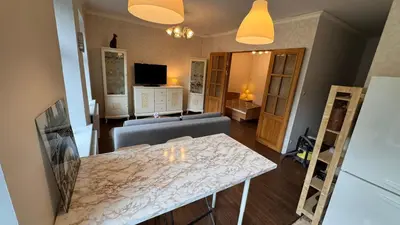 a living room with a table and a couch at Cozy stay Vilnius in Vilnius