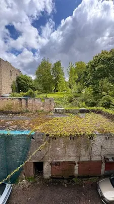 an old building with plants on the top of it at Cozy stay Vilnius in Vilnius