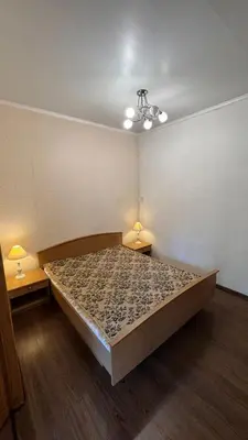 a large bed in a room with two lamps at Cozy stay Vilnius in Vilnius