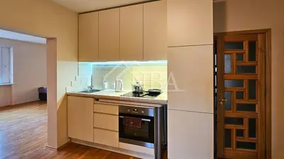 a kitchen with a stove top oven next to a refrigerator at Guest house Sunrise in Šiauliai