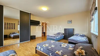 a room with two beds and a mirror at Guest house Sunrise in Šiauliai