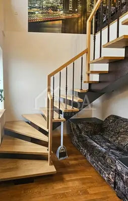a staircase in a house with a couch under it at Guest house Sunrise in Šiauliai