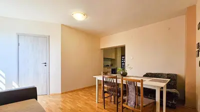 a living room with a table and chairs and a couch at Guest house Sunrise in Šiauliai