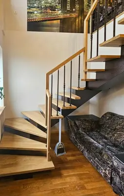 a living room with stairs and a couch at Guest house Sunrise in Šiauliai