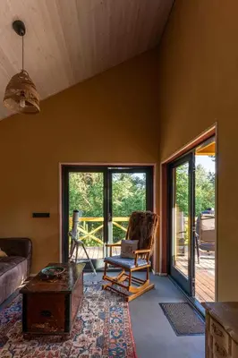 a living room with a couch and a chair at Getlost cabins in Valanciunai