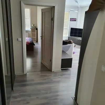 a hallway with a door open to a bedroom at Apartment Beauty in Vilnius
