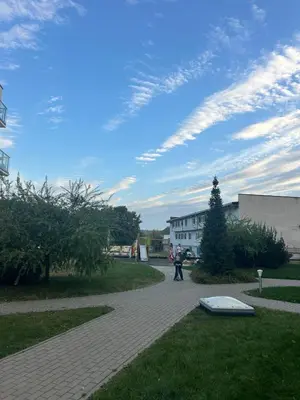 a person walking down a brick walkway in a park at Flat in central of Vilnius in Vilnius