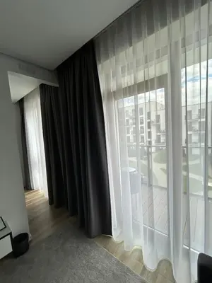 a room with a large window with a view of a building at Flat in central of Vilnius in Vilnius