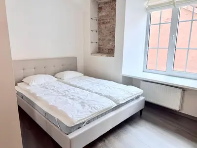 a white bed in a room with a window at Pilies8 Luxury Vilnius Apartment in Vilnius