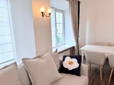 a living room with a couch and a window at Pilies8 Luxury Vilnius Apartment in Vilnius