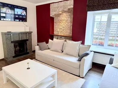 a living room with a white couch and a fireplace at Pilies8 Luxury Vilnius Apartment in Vilnius