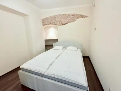 a bedroom with a bed in a white room at Pilies8 Luxury Vilnius Apartment in Vilnius