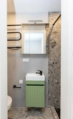 a bathroom with a green sink and a mirror at Trumpalaikė butų nuoma Kaune prie Klinikų MINIUKAS SELF CHECK-IN in Kaunas