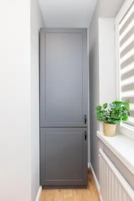 a gray door in a room with a plant at Trumpalaikė butų nuoma Kaune prie Klinikų MINIUKAS SELF CHECK-IN in Kaunas