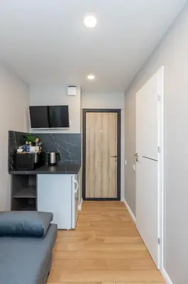 a kitchen with a door leading to a living room at Trumpalaikė butų nuoma Kaune prie Klinikų MINIUKAS SELF CHECK-IN in Kaunas