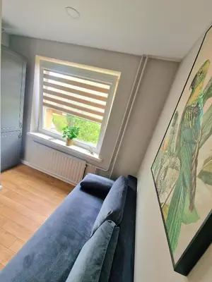 a living room with a couch and a window at Trumpalaikė butų nuoma Kaune prie Klinikų MINIUKAS SELF CHECK-IN in Kaunas