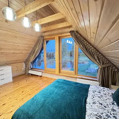 a bedroom with a bed and a large window at 12 Bijūnų in Joniškis