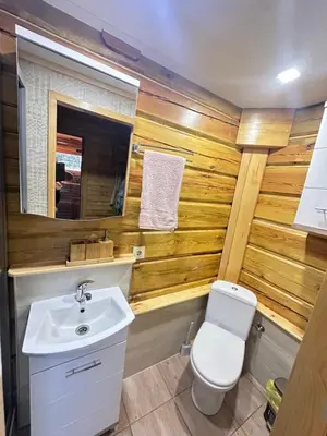 a bathroom with a toilet and a sink at 12 Bijūnų in Joniškis