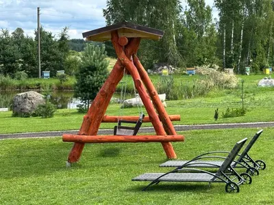 a wooden play structure with two chairs and a table at 12 Bijūnų in Joniškis