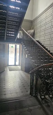 a spiral staircase in a building with a hallway at Telegrafas25-modern apartment in the center of Kaunas in Kaunas