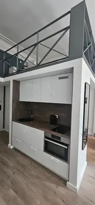 a kitchen with white cabinets and a microwave at Telegrafas25-modern apartment in the center of Kaunas in Kaunas