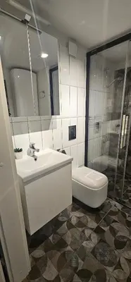 a bathroom with a sink and a shower and a toilet at Telegrafas25-modern apartment in the center of Kaunas in Kaunas