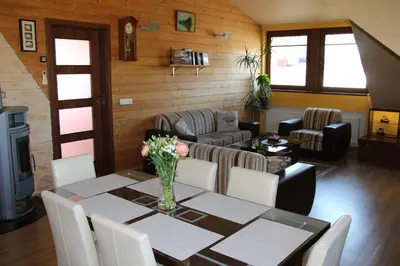 a dining room with a table and a couch at KaunaStayIn in Kaunas