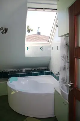 a bathroom with a large tub and a window at KaunaStayIn in Kaunas