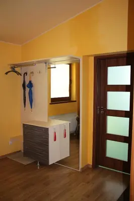 a room with yellow walls and a window and a door at KaunaStayIn in Kaunas