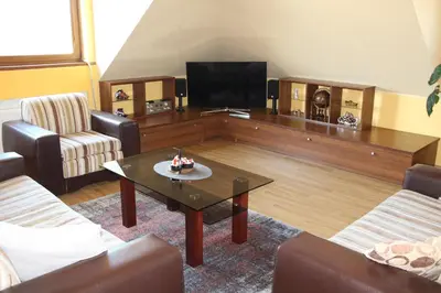 a living room with a coffee table and a flat screen tv at KaunaStayIn in Kaunas