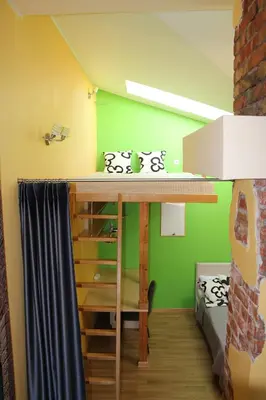a bunk bed in a room with a green wall at KaunaStayIn in Kaunas