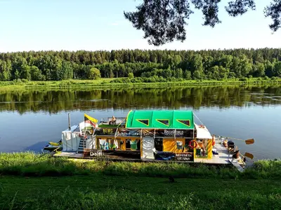a boat is docked on a river at Nemo Keliones in Druskininkai